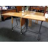 Two mid 20th century teak bed tables on metal legs.
