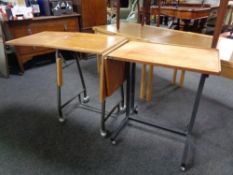 Two mid 20th century teak bed tables on metal legs.