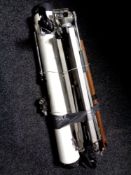 A telescope together with three assorted tripods