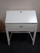 An Ikea writing bureau, fitted a drawer, on raised legs.