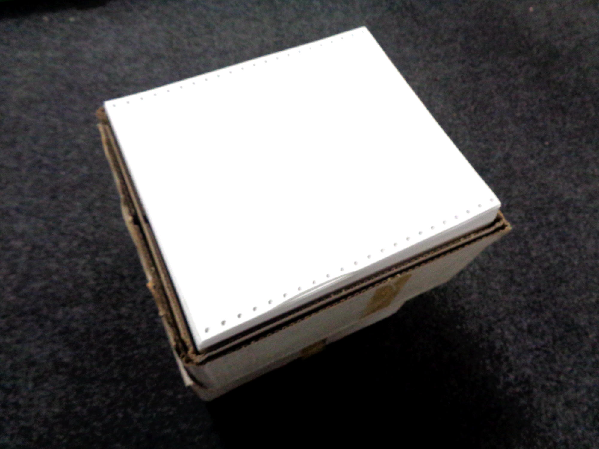 Nine boxes containing Viking continuous listing printer paper.