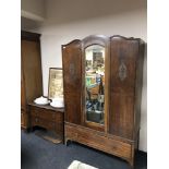 A 1930s oak mirror door wardrobe, fitted drawer beneath, together with two drawer chest,