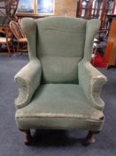 A 19th century wingback armchair on club feet (a/f)