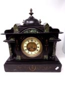A 19th century black slate and marble mantel clock with a brass and enamel dial.