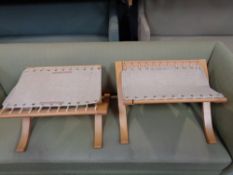 A pair of folding beech canvas webbed footstools.