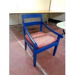 An antique painted kitchen armchair