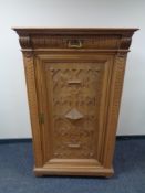 A 20th century carved oak cabinet, fitted drawer above.