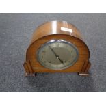 A 1930s oak cased Garrard mantel clock with silver dial, pendulum and key.