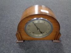 A 1930s oak cased Garrard mantel clock with silver dial, pendulum and key.