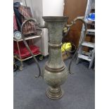 A large Eastern brass floor standing twin handled vase, height 101 cm.