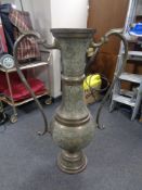 A large Eastern brass floor standing twin handled vase, height 101 cm.