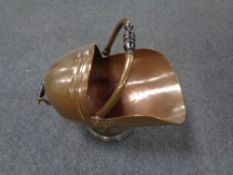 An antique copper coal helmet
