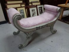 A contemporary silver window seat upholstered in a pink fabric.