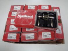 A box containing a quantity of Kwikset door handles.