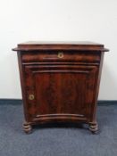 A 19th century mahogany concave cabinet, fitted a drawer above.