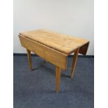 A 20th century pine drop leaf kitchen table.