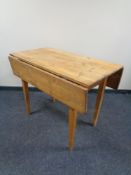 A 20th century pine drop leaf kitchen table.