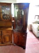 An inlaid mahogany corner display cabinet fitted cupboard beneath