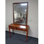 A mahogany two drawer hall table on reeded legs together with a nest of three matching tables,