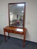 A mahogany two drawer hall table on reeded legs together with a nest of three matching tables,