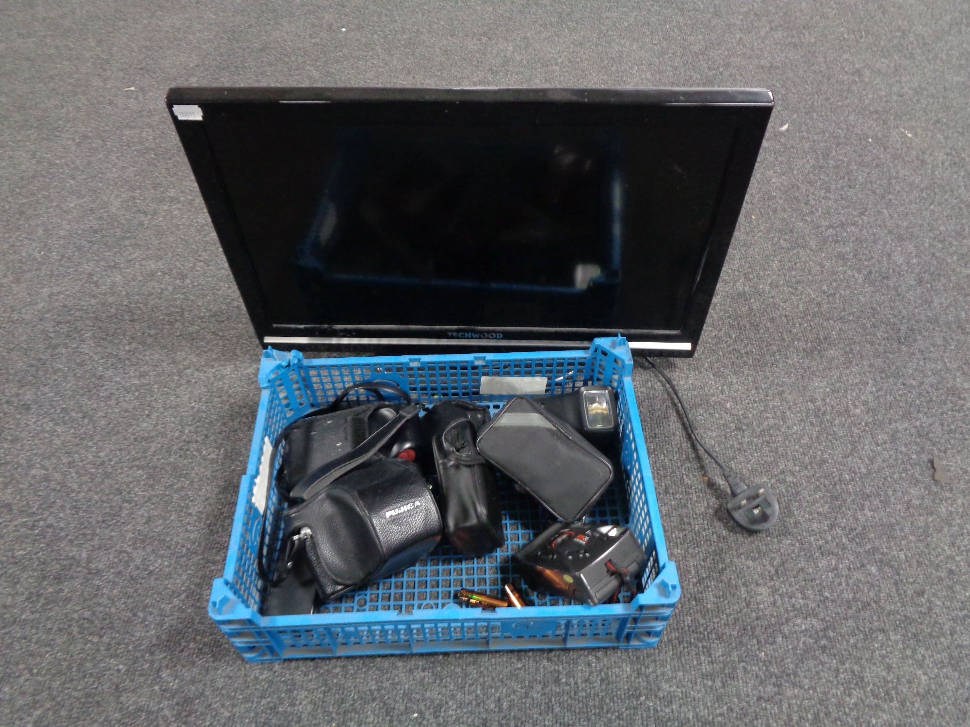 A Techwood 22'' LCD TV DVD together with a crate containing a small quantity of cameras.