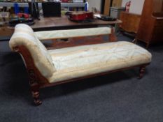 A late 19th century carved oak framed chaise longue upholstered in a striped Regency style fabric.