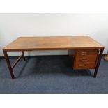 A mid 20th century Danish teak single pedestal writing desk, fitted three drawers and a slide.