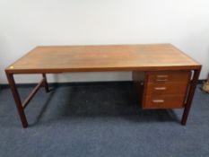 A mid 20th century Danish teak single pedestal writing desk, fitted three drawers and a slide.