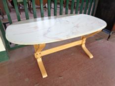 A late 20th century oval marble effect coffee table on beech base