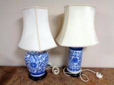 Two Chinese style blue and white table lamps with shades.