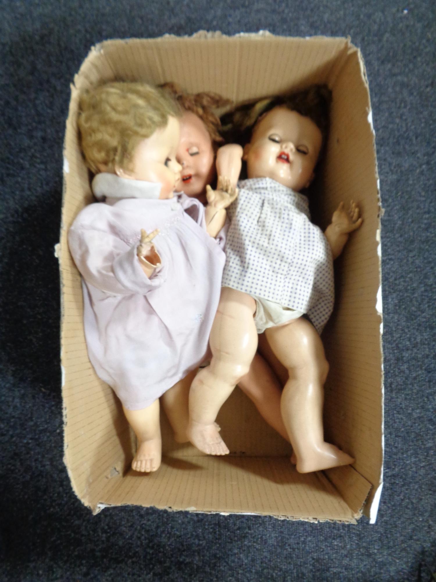 A box of three mid 20th century plastic dolls