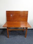 A mid 20th century mahogany turnover top coffee table.