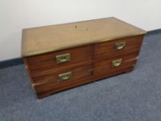 A mahogany campaign style four drawer chest with brass mounts and handles with tooled leather panel