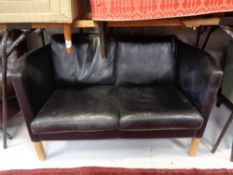 A 20th century Danish black leather two seater settee.