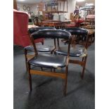 A set of three Danish mid 20th century teak elbow chairs upholstered in a black vinyl (a/f)