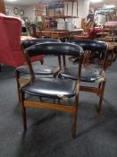 A set of three Danish mid 20th century teak elbow chairs upholstered in a black vinyl (a/f)