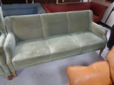 A 20th century three seater settee upholstered in a green dralon.