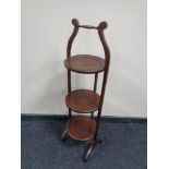 An early 20th century mahogany three tier folding cake stand.