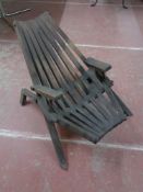A wooden slatted garden lounger chair