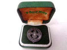 A silver boy scout With Thanks badge in original box.