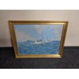 A gilt framed oil on canvas depicting fishing boats off a headland, indistinctly signed.