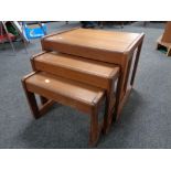 A nest of three 20th century teak tables.