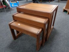 A nest of three 20th century teak tables.