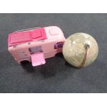 A Barbie mobile home together with a globe on stand