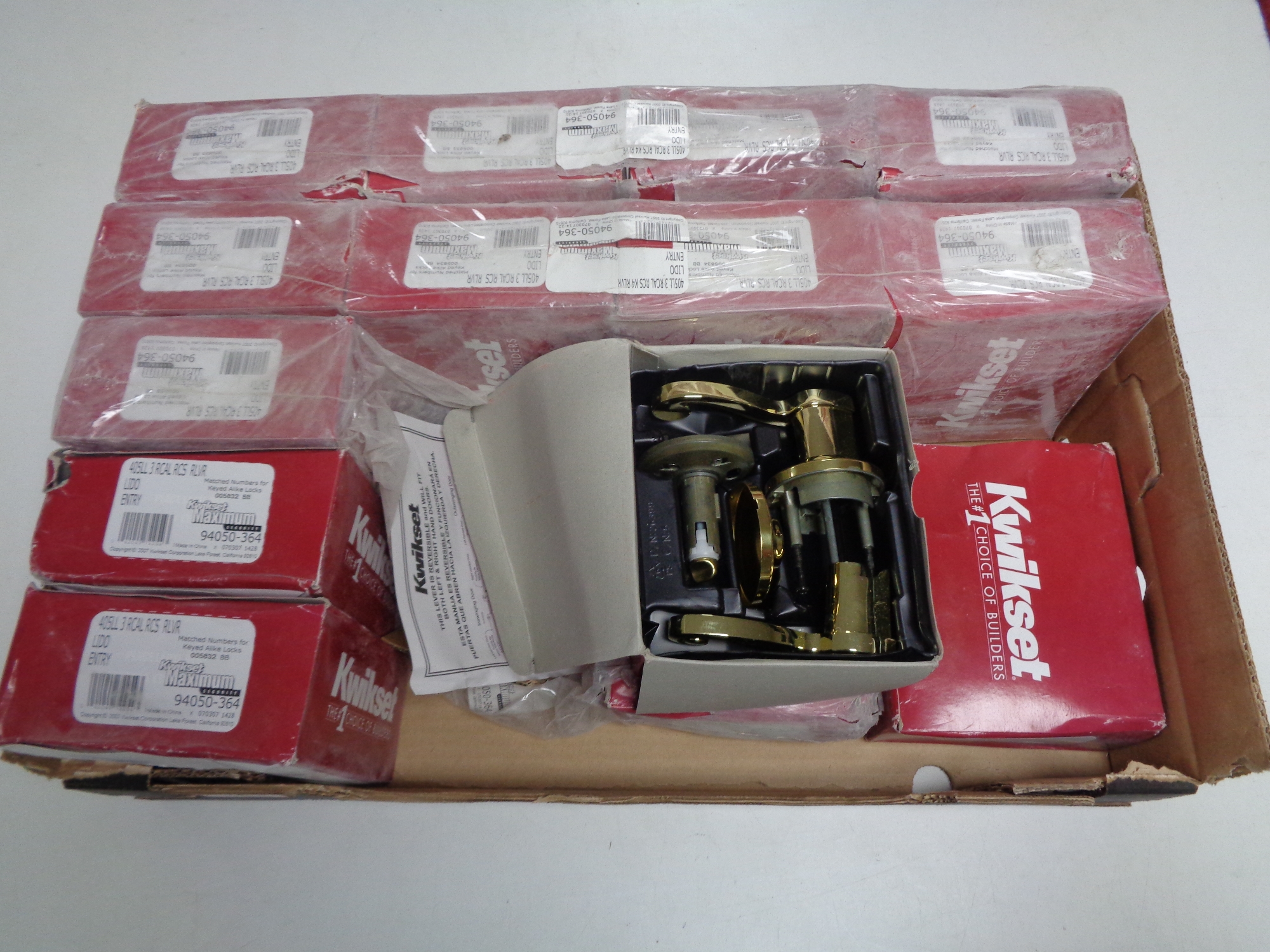 A box containing a quantity of Kwikset door handles.