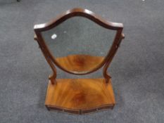 A 19th century mahogany shield dressing table mirror, fitted two drawers.