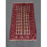 A Baluchi rug 129cm by 76cm