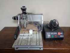 A CNC 4030Z Axis desktop engraving machine router with water cooling spindle.