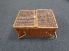 A wicker twin-handled picnic hamper