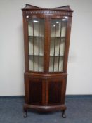 An Edwardian mahogany double door corner display cabinet, fitted cupboards below,